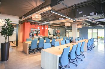 a large conference room with blue chairs and tables